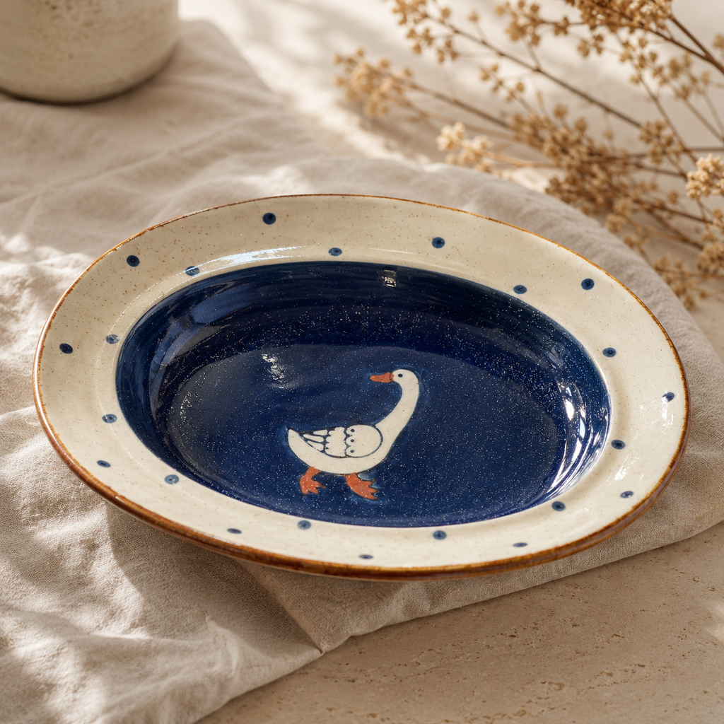 Goose ceramic oval deep plate displayed in a warm neutral tabletop setting