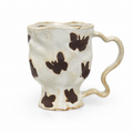 Handmade butterfly ceramic mug with wavy rim, sculptural handle, and ivory glaze