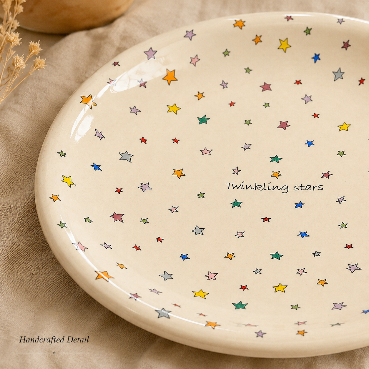 Close-up of colorful star artwork and Twinkling Stars lettering on glazed ceramic plate