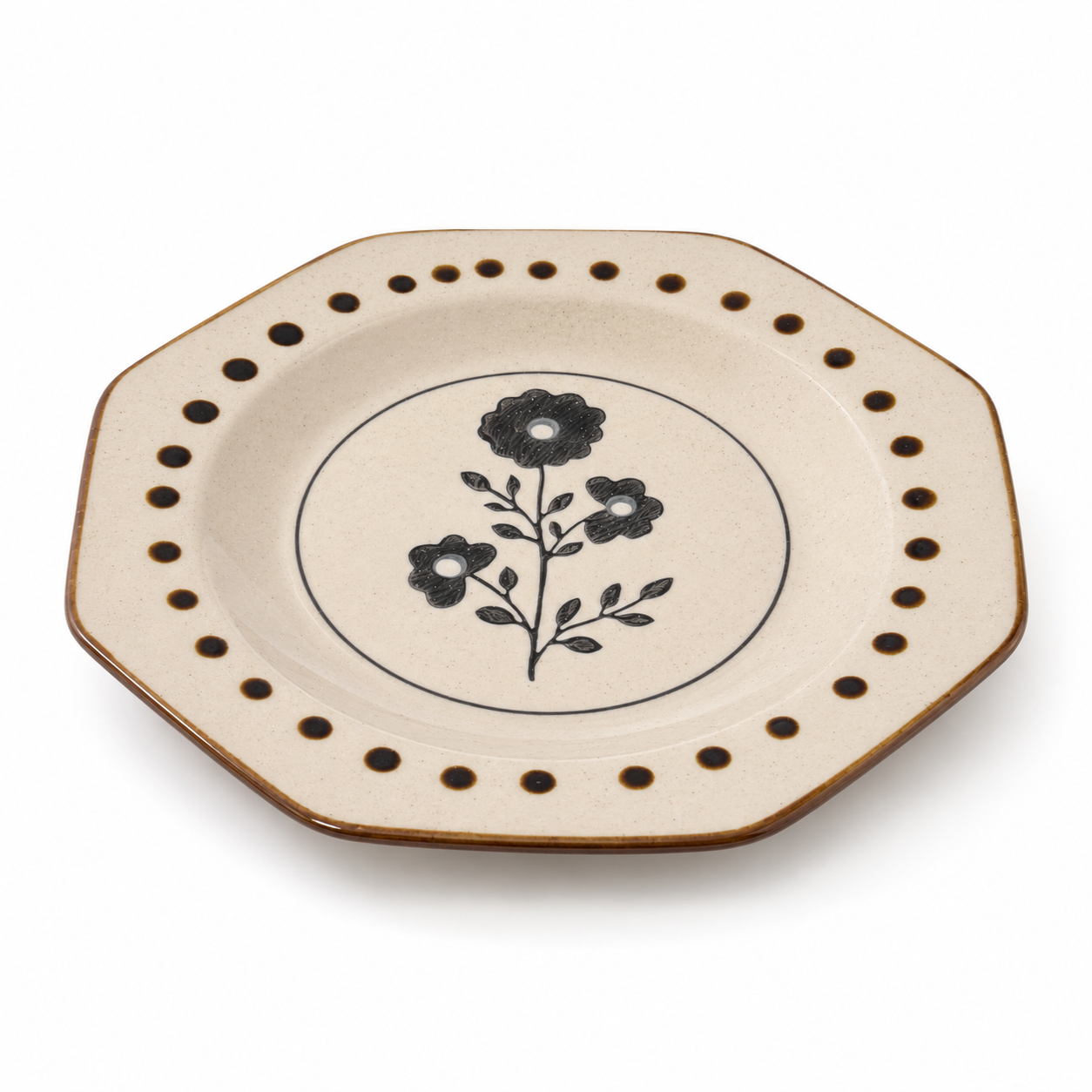 Black floral ceramic plate with brown dot border and speckled cream glaze