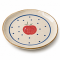 Apple ceramic dinner plate with red apple, blue dots, and speckled cream glaze