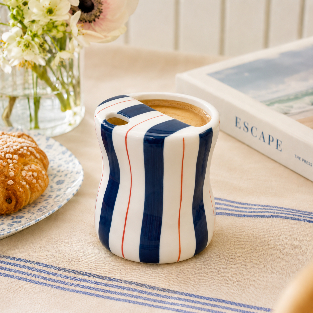 Navy striped ceramic mug with coffee in a bright breakfast setting